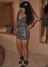 Nikki Montero in a motel trying out various outfits and toying her ass with a water bottle